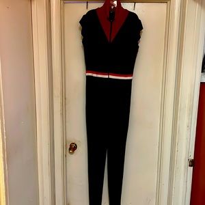 Green pants jumpsuit with red, black and white around waist. New size 1x